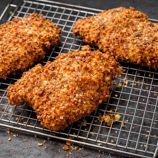 Golden fried chicken cutlets with a crackly crust on a wire rack